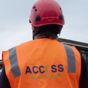 Building maintenance worker with hard hat and safety vest. Property maintenance and building trades services.